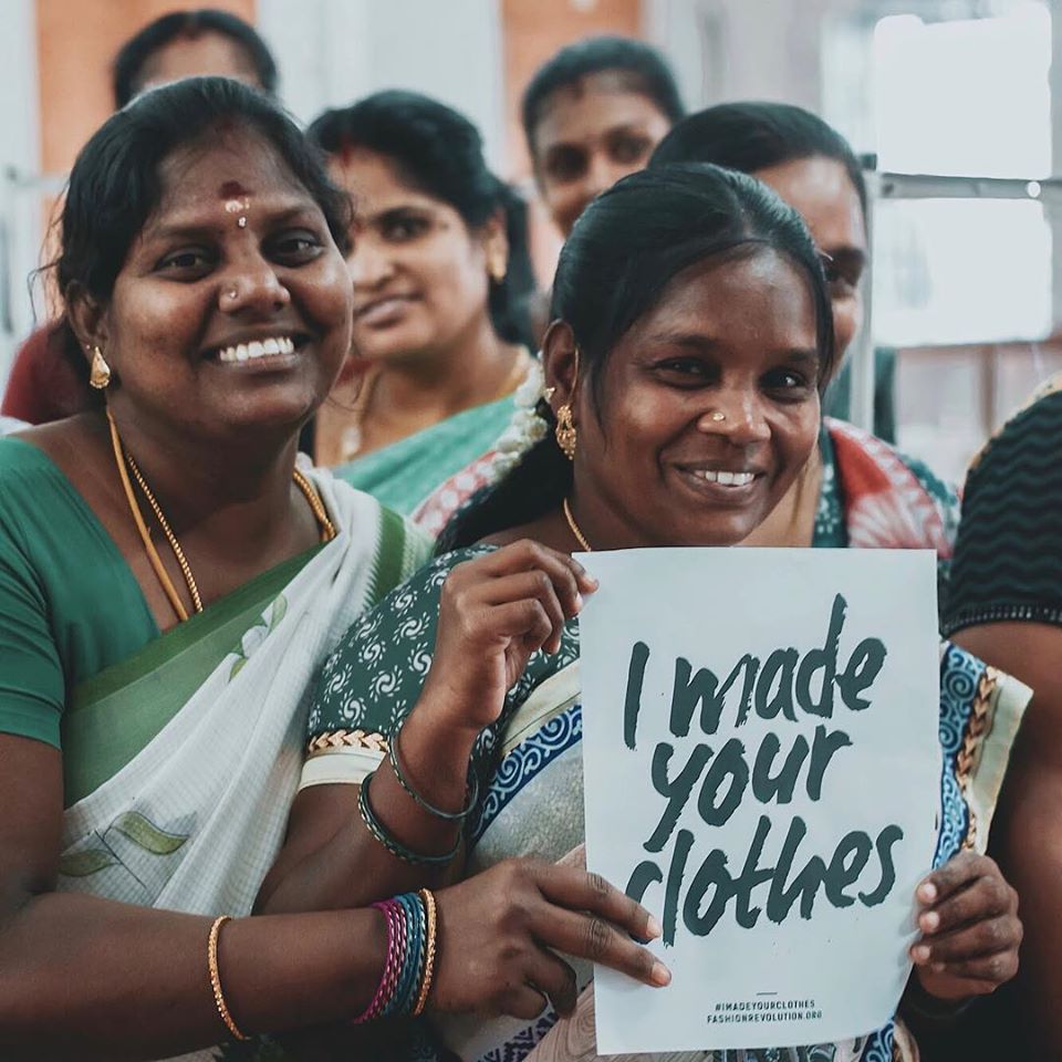 Group of Indian women smiling with a sign that says I made your clothes