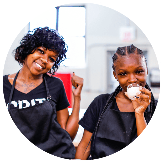Smiling women making candles