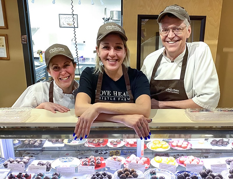 Confections with Convictions team posing with their chocolate creations
