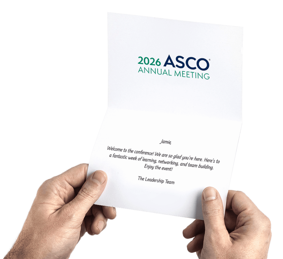 Hands holding a card with conference logo and welcome message