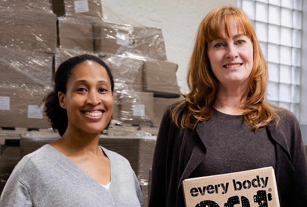 Founders of Every Body Eat smiling with their product