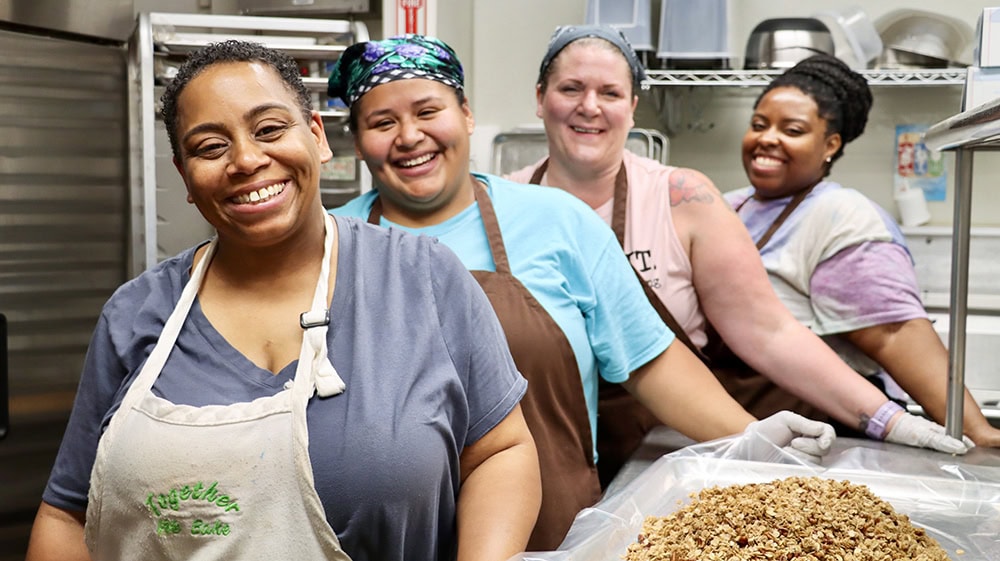 A group of smiling women participants of the Together We Bake program