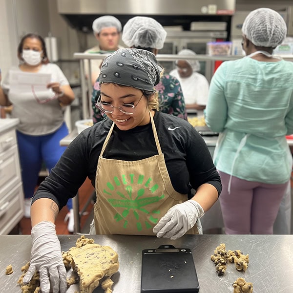 Woman rolling out dough for cookies