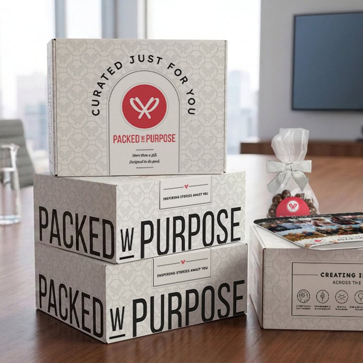 A stack of Packed with Purpose gifts on a conference table