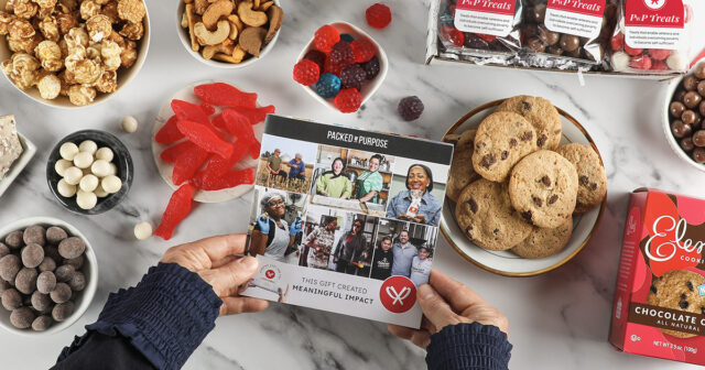 Overhead of a gift spread across a tabletop with hands holding a booklet