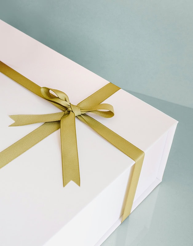 Close up of a gift box with a gold ribbon