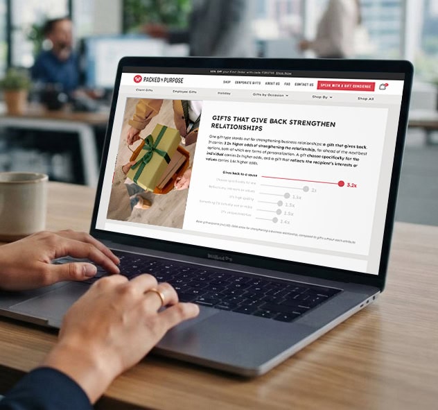 A woman at a laptop reviewing the Packed with Purpose Corporate Gifting Report