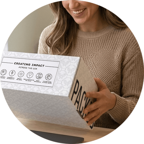 Woman smiling while receiving a Packed with Purpose gift